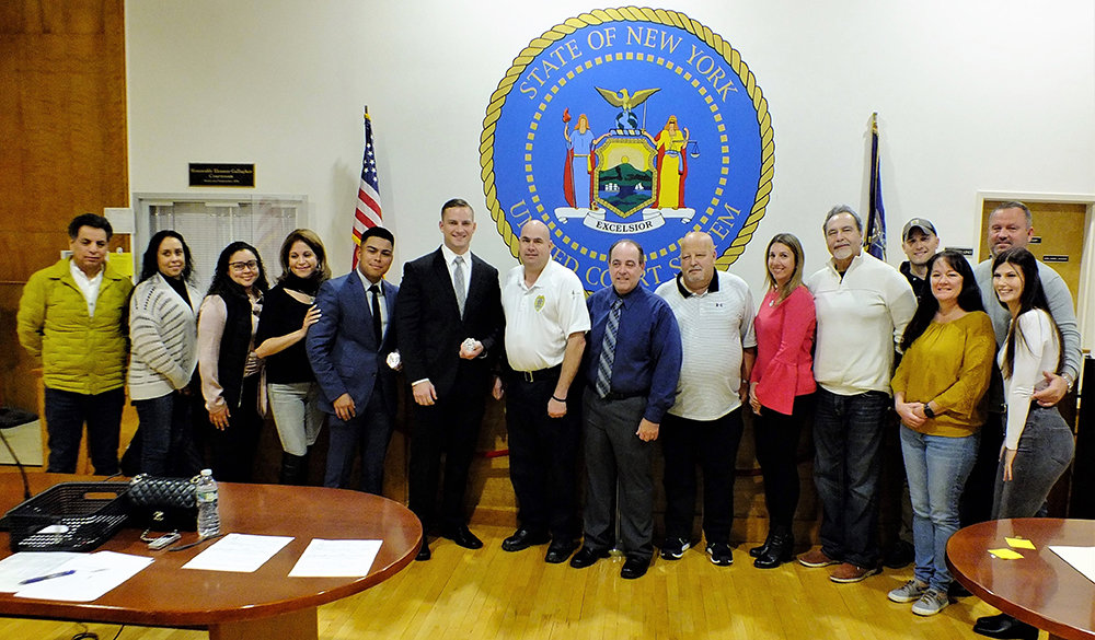 Friends and family turned out for the appointment of two new police officers Kevin Coronel and Frank Zebrowski, 5th and 6th from the left respectively, who are standing next to Police Chief Gerald Cocozza who is standing in the center.